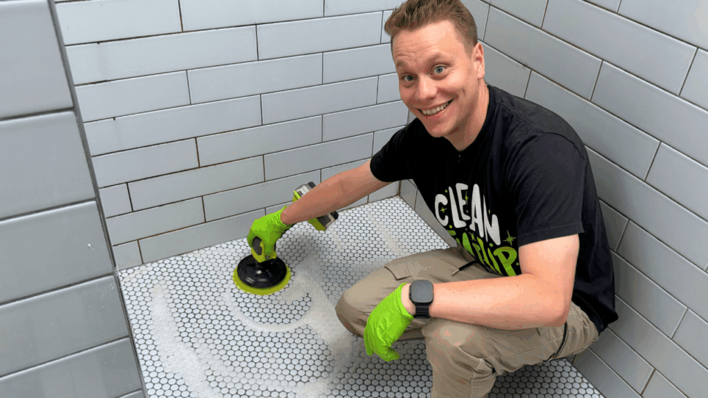 brandon using drill brush to clean tile and grout